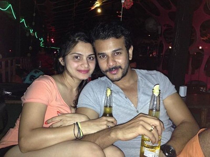 Jay Soni is seen holding a bottle of beer along with his wife