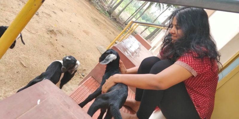 Leena Manimekalai playing with goats