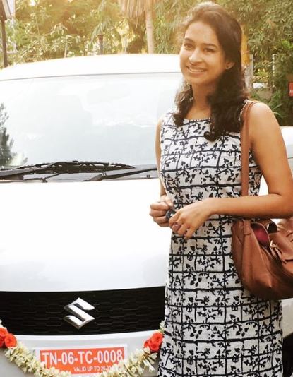 Misha Ghoshal posing with her car