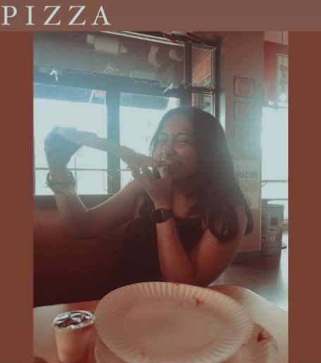 An Instagram post by Aarya Walvekar while eating pizza