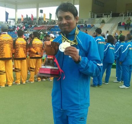Dinesh Kumar posing after winning medals in Lawn Bowls Championships
