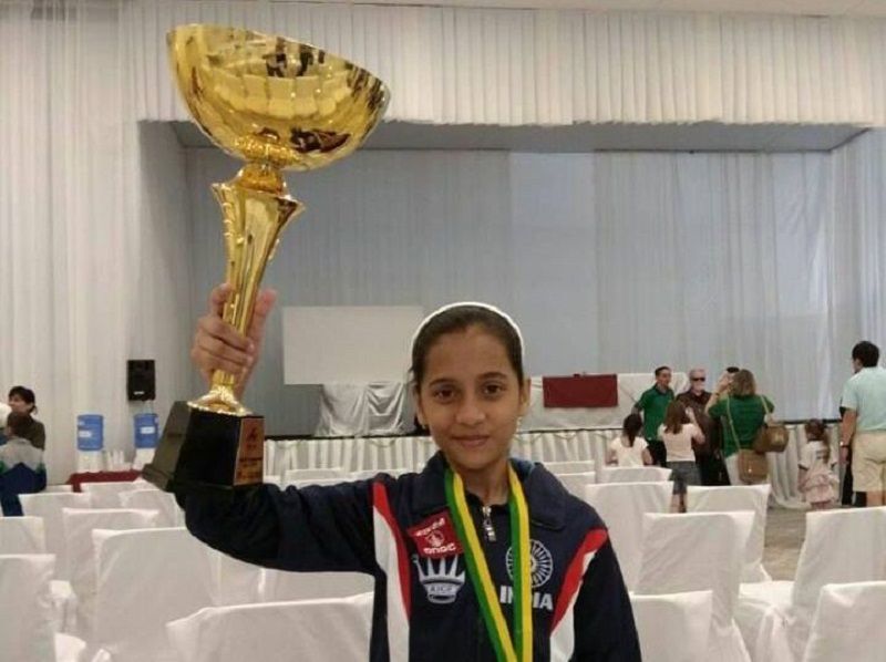 Divya Deshmukh posing with the World Cadets Chess Championship trophy