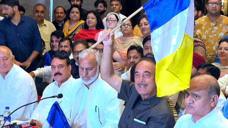 Ghulam Nabi Azad holding the flag of his new political party, Democratic Azad Party