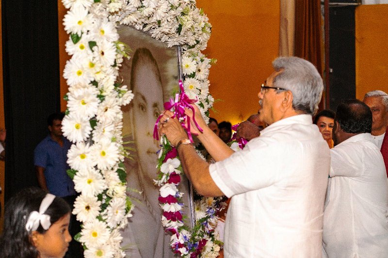 Gotabaya Rajapaksa, elder brother of Basil, offering a garland at his mother's portrait during the death anniversary of his mother