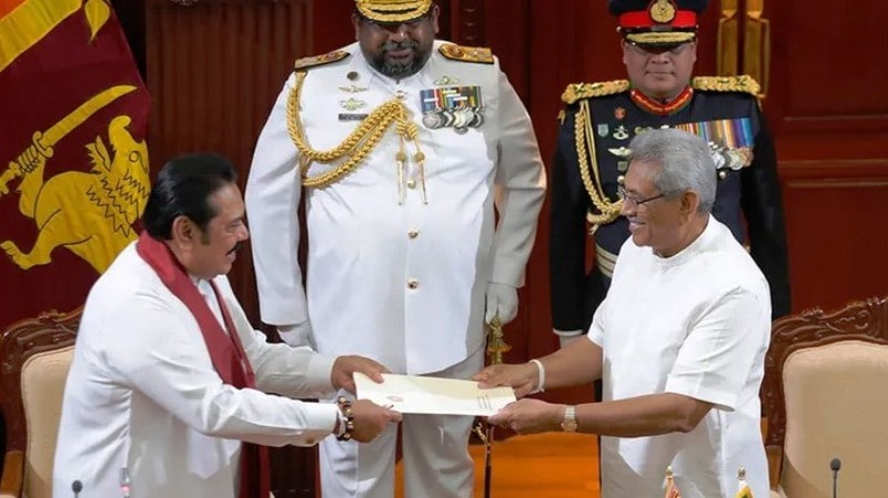 Gotabaya (right) accepting document from Mahinda (left) after appointing him as the Prime Minister