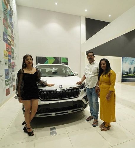 Jayshree Aradhya and her parents posing with their new car