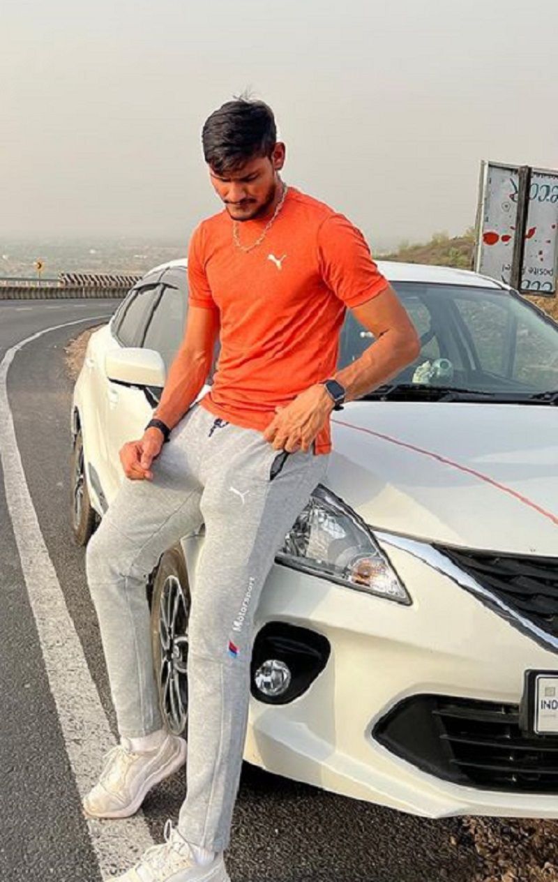 Kuldeep Sen posing with his car