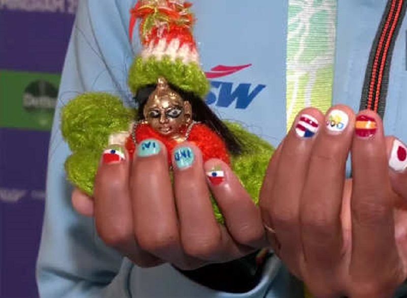 Priyanka Goswami's nail paint and idol of Lord Krishna during the CWG 2022