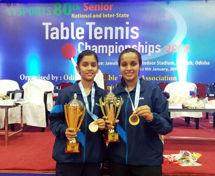 Sreeja Akula with her women's doubles partner, holding her gold medal