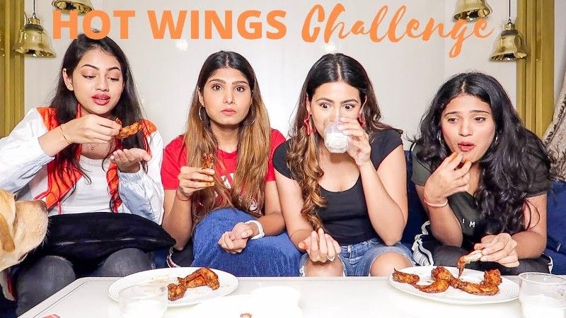 A challenge video posted by Aashna Hegde (second from right) with her sisters on YouTube in which they were seen eating hot chicken wings