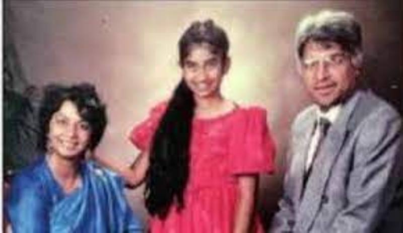 A childhood image of Suella, at the age of 6, with her parents