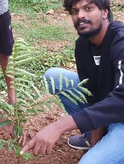 Adi Reddy while planting a sapling