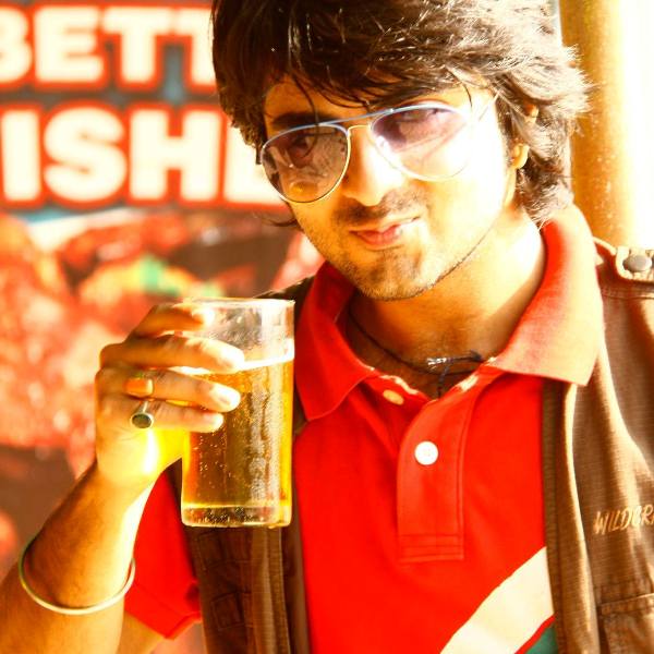 Akash Arora holding a glass of beer
