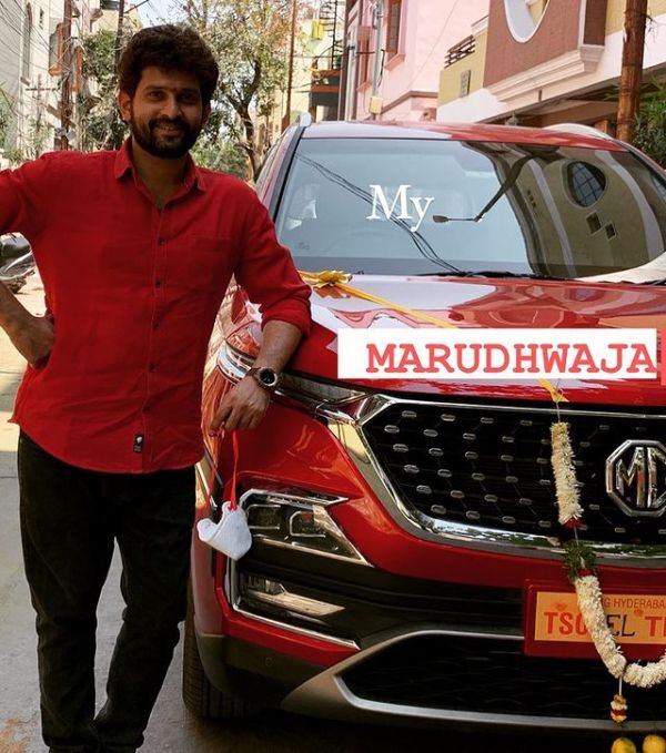 Baladitya posing with his brand-new car