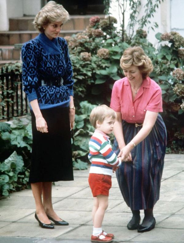 Diana, Princess of Wales, looking on Jane Mynors and Prince William as Mynors greets the prince at the nursery school she ran in London on 24 September 1985