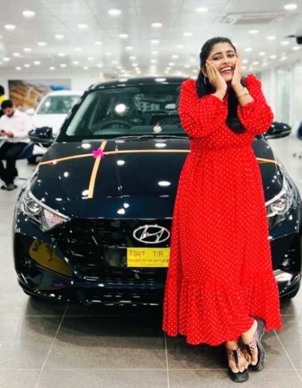 Geetu Royal standing in front of her Hyundai i20