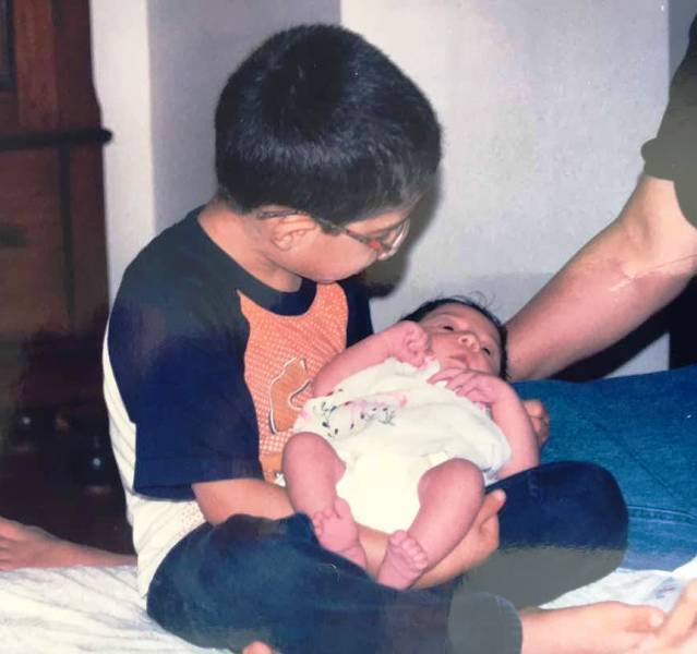 Ira Khan as an infant in her brother Junaid Khan's lap