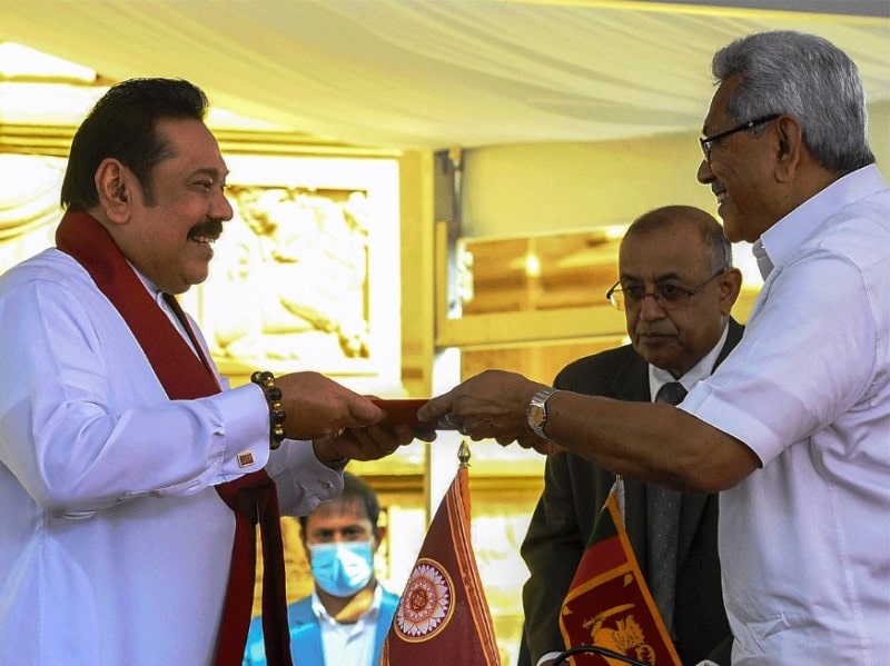 Mahinda Rajapaksa (left) handing over documents to Gotabaya Rajapaksa after taking oath as the Prime Minister of Sri Lanka