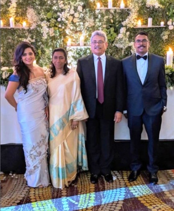 Manoj Rajapaksa standing with his father, mother, and wife