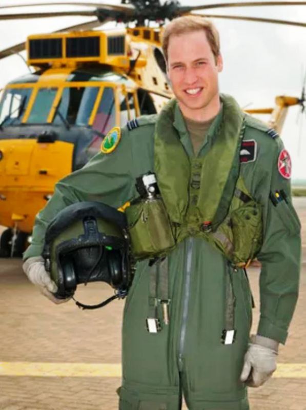 Prince William as a RAF pilot in 2012 posing in front of a Sea King