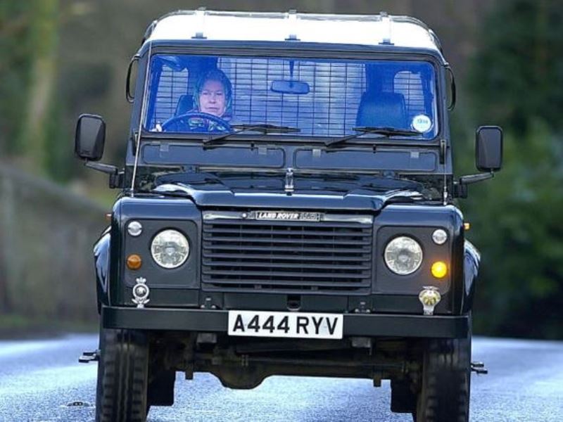 Queen Elizabeth II driving a 2000 Land Rover Defender 110 