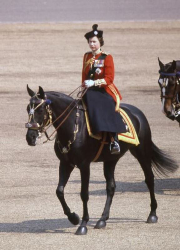 Queen riding on her horse, Burmese, for the Trooping the Colour ceremony