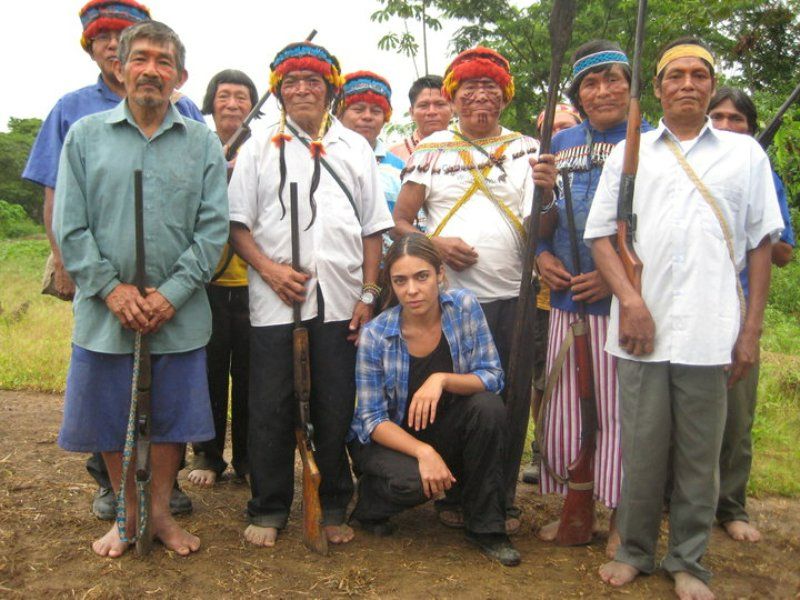 Ramita Navai with the tribesmen in the remote village of Washintsa, in the Pastaza river basin, and people from neighbourhood to save their lands from being bought by the global corporations