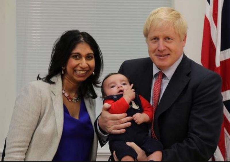 Suella Braverman with then Prime Minister of the UK, Boris Jhonson holding her son, George