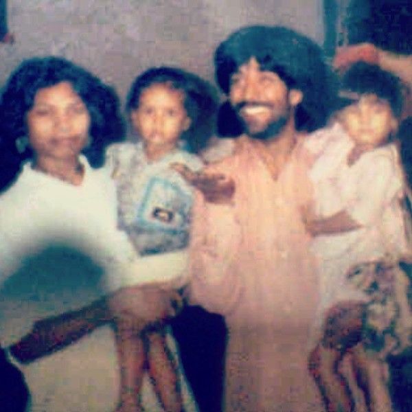 A young-age photograph of Parag Kansara with his wife and children