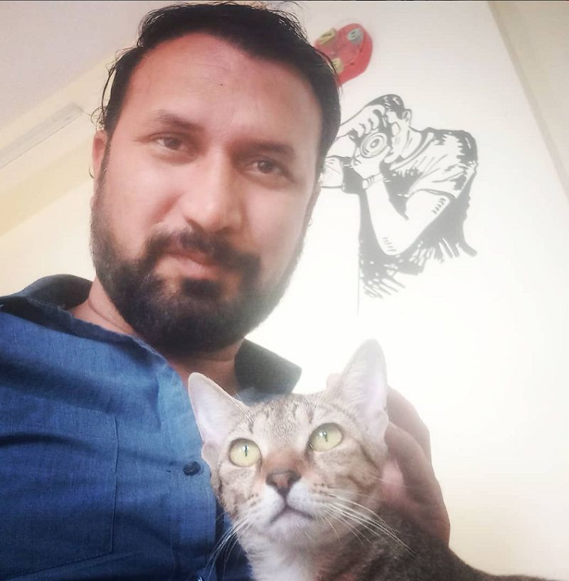 Chandresh Singh posing with cat