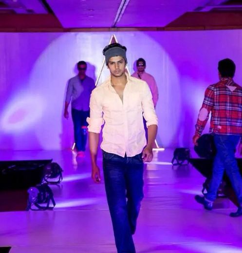 Darsh Chandrappa walking the ramp at a fashion show