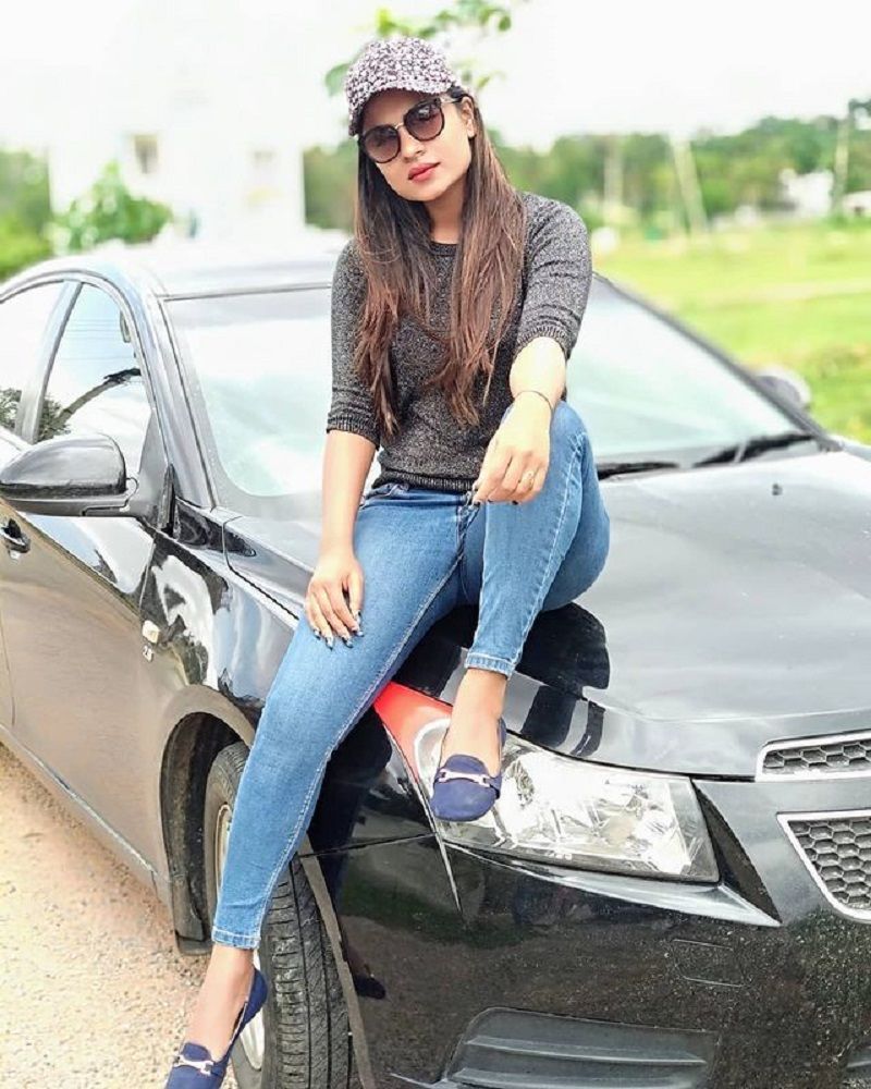 Deepika Das posing with her car