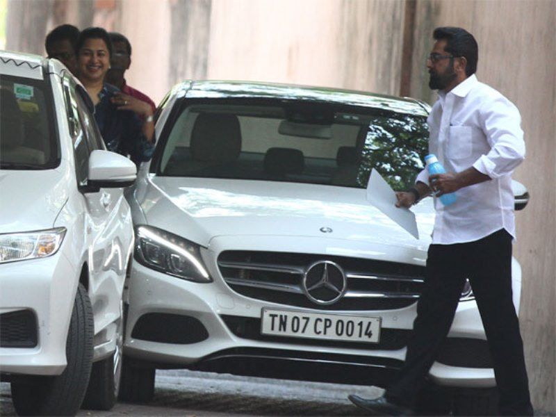 R. Sarathkumar walking past his Mercedes-Benz C-Class car
