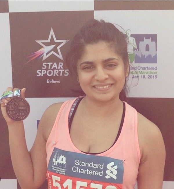 Sandhya Shekar with medal for completing half marathon in 2015.