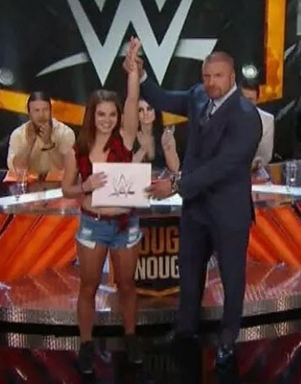Sara Lee, along with Triple H, posing after winning the Tough Enough competition