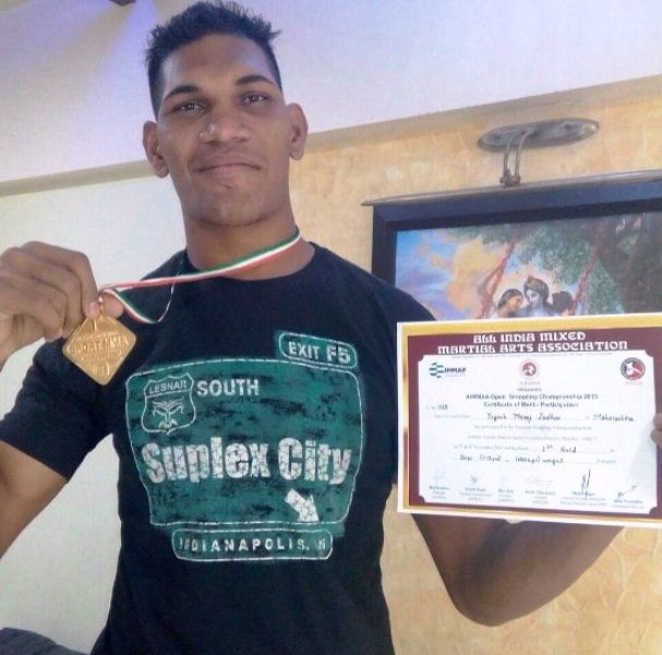 Yogesh Jadhav's photograph with his gold medal that he won at the National MMA Championship