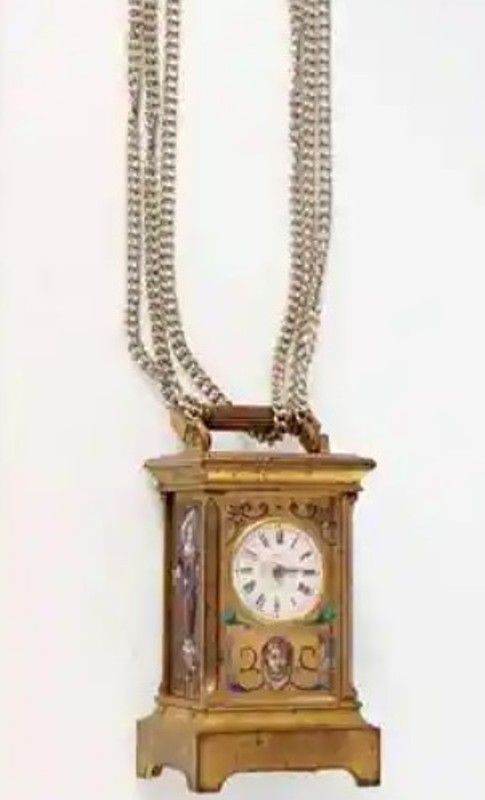 A miniature grandfather clock used as a pendant by Suhani Pittie
