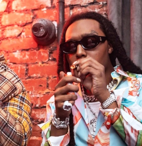 A photo of Takeoff taken while he was lighting a cigar