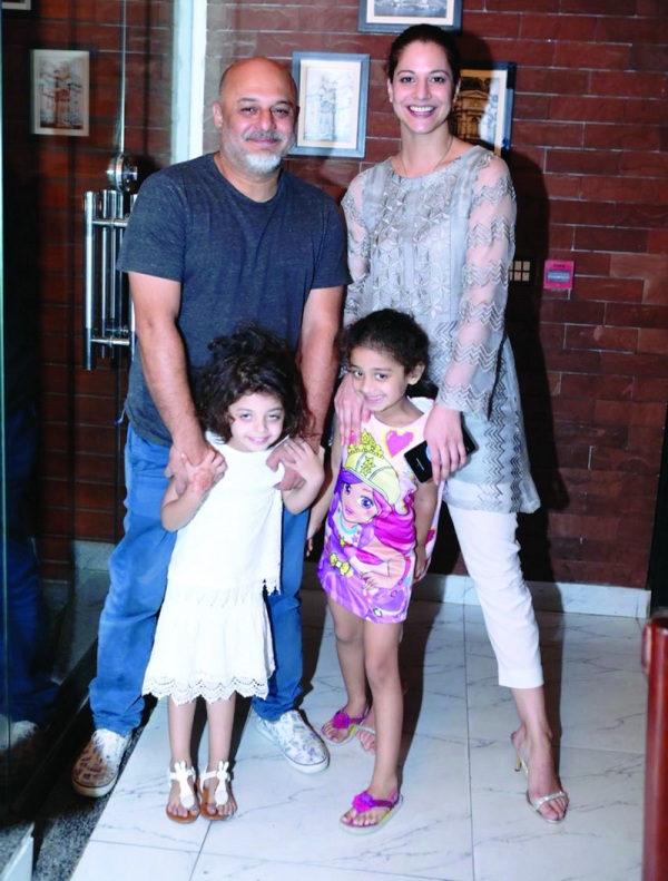 A picture of Ali Azmat with his wife and daughter