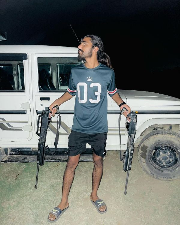 A picture of Rohit Bhati while holding firearms