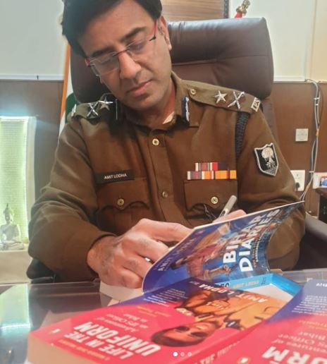 Amit Lodha signing his book Life in the Uniform