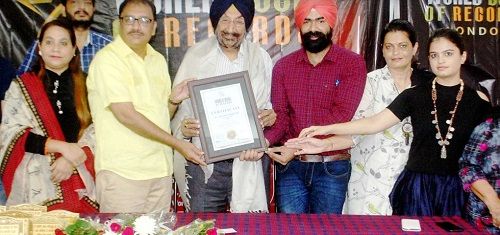Jaswant Singh Gill receiving a certificate from the World Book of Records