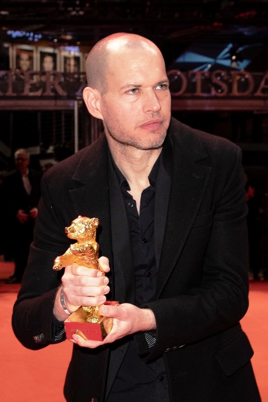 Nadav Lapid holding the Golden Bear Award that his directed film Synonyms won