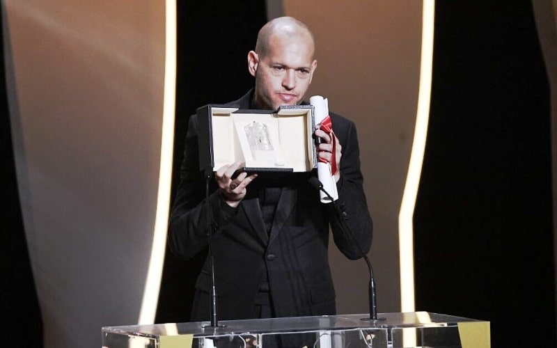 Nadav Lapid holding the Jury Prize that his directed film Ahed's Knee won at the 2021 Cannes Film Festival