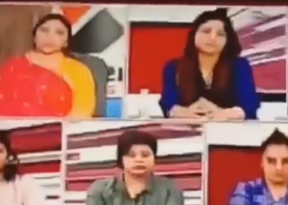 Naina Jadeja (in red and yellow attire) on a news channel panel