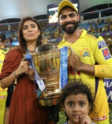 Rivaba Jadeja posing with her husband and trophy