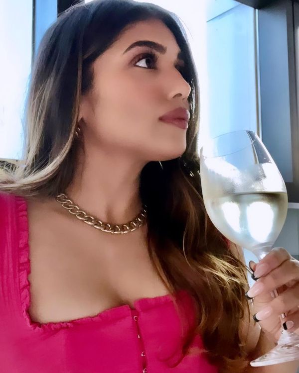 Samiksha Pednekar holding a glass of wine