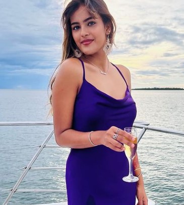 Shrea Prashad while holding a glass of alcohol