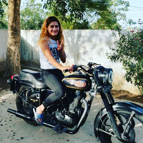 Suchika Tariyal riding a motorcycle