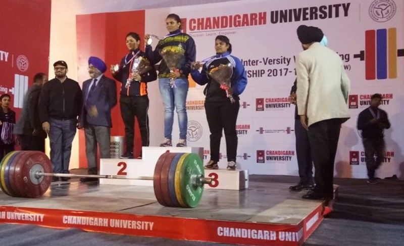 Usha Kumara on podium after winning gold in All India Inter University Powerlifting Championship in 2017